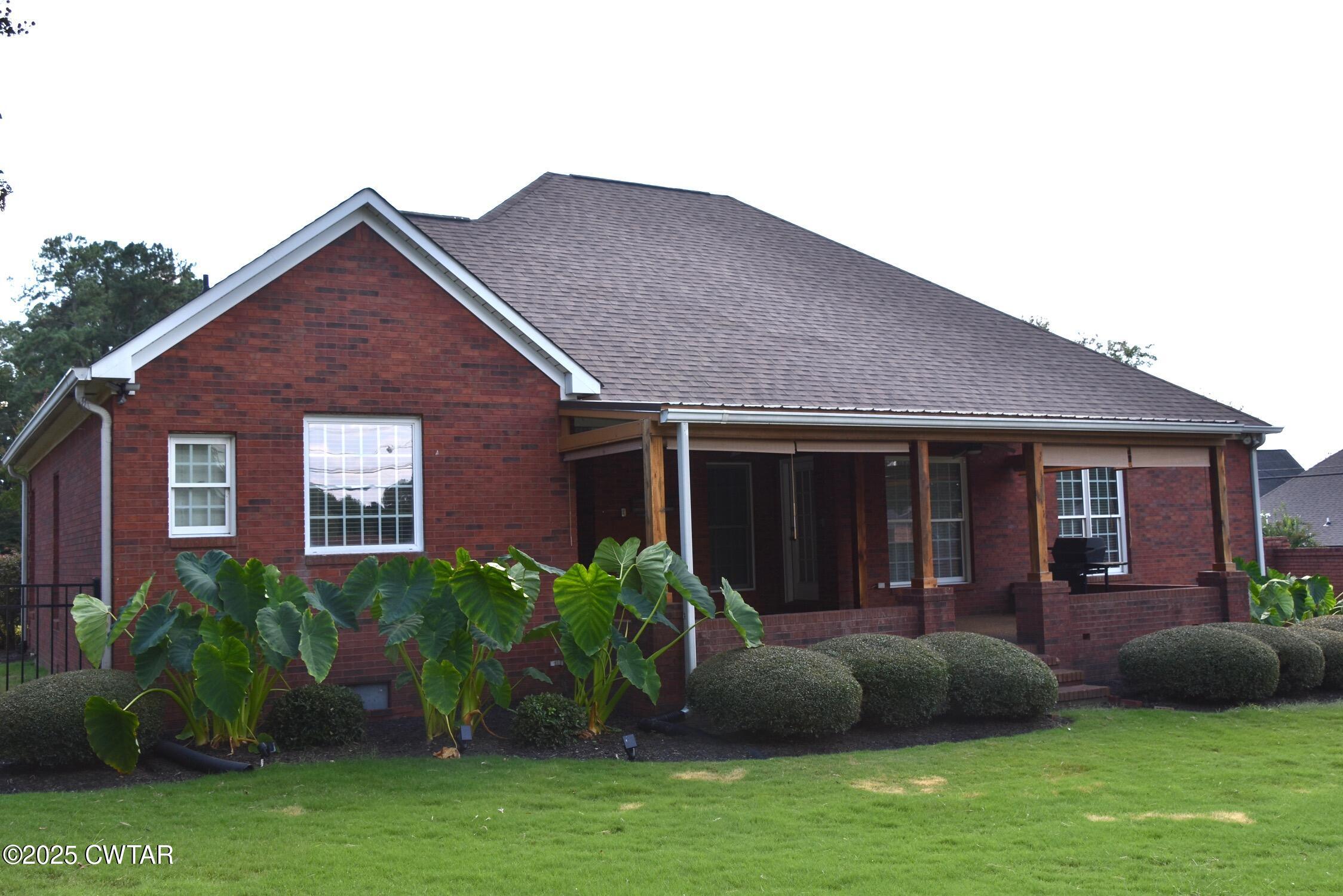 7 Sutton Place Jackson, TN 38305 - Photo 5 of 25 a view of a house with a yard and plants