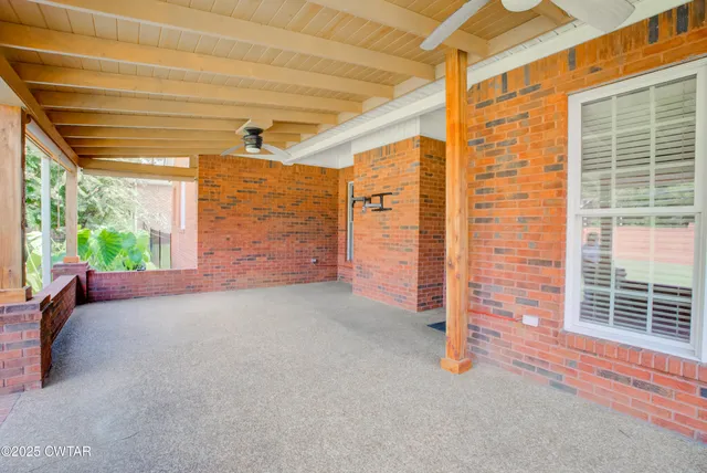 a view of a porch with a table and chairs