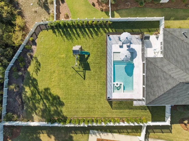 a view of swimming pool with a yard and seating area