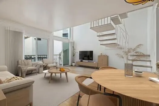 a living room with furniture kitchen view and a flat screen tv