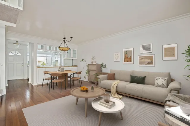 a living room with lots of furniture and view of kitchen
