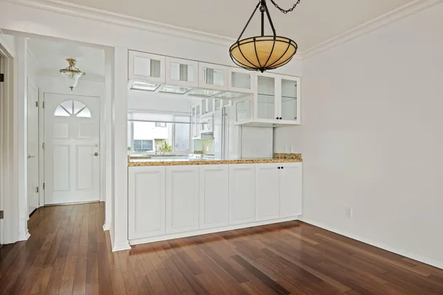 a kitchen with wooden floor and window