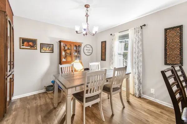 a view of a dining room with furniture and a chandelier