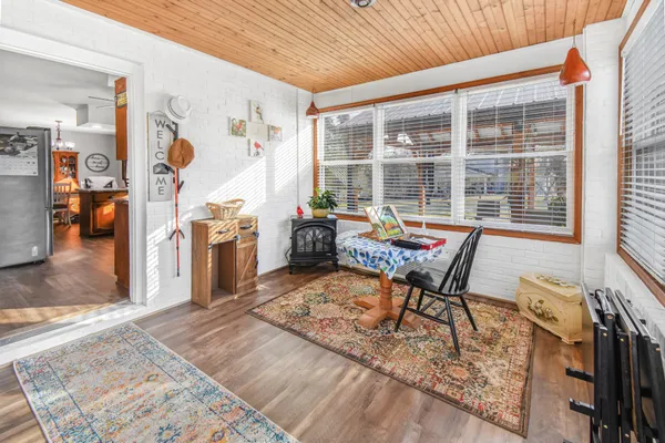 a reading room with furniture a rug and a window