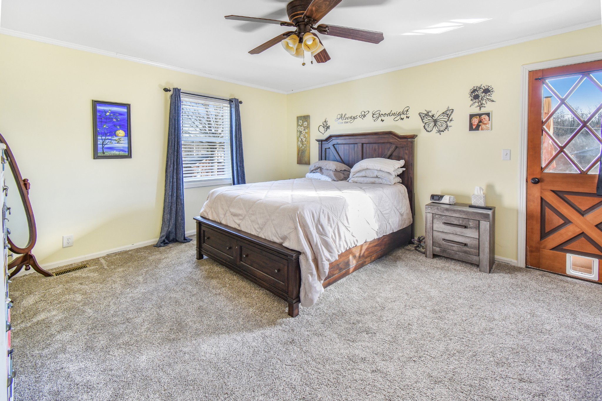 55 Morris Lane Carthage, TN 37030 - Photo 20 of 47 a spacious bedroom with a bed and a chandelier
