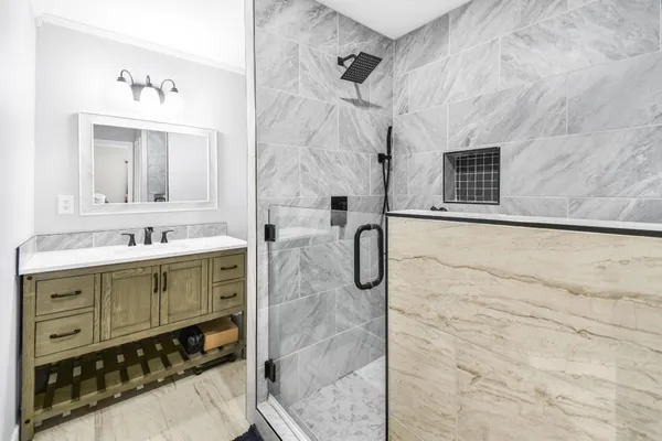a bathroom with a sink double vanity and a mirror