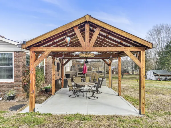 a view of a patio with a table and chairs
