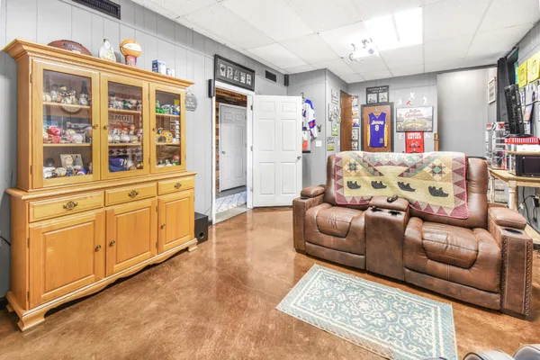 a view of a livingroom with workspace and a window
