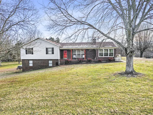a house view with swimming pool in front of it