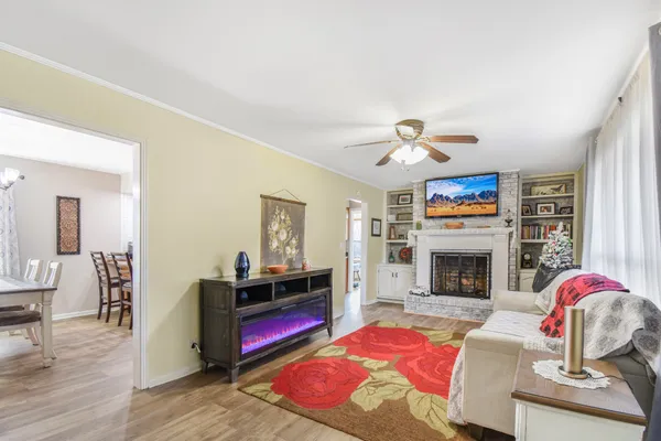 a living room with furniture flat screen tv and a fireplace