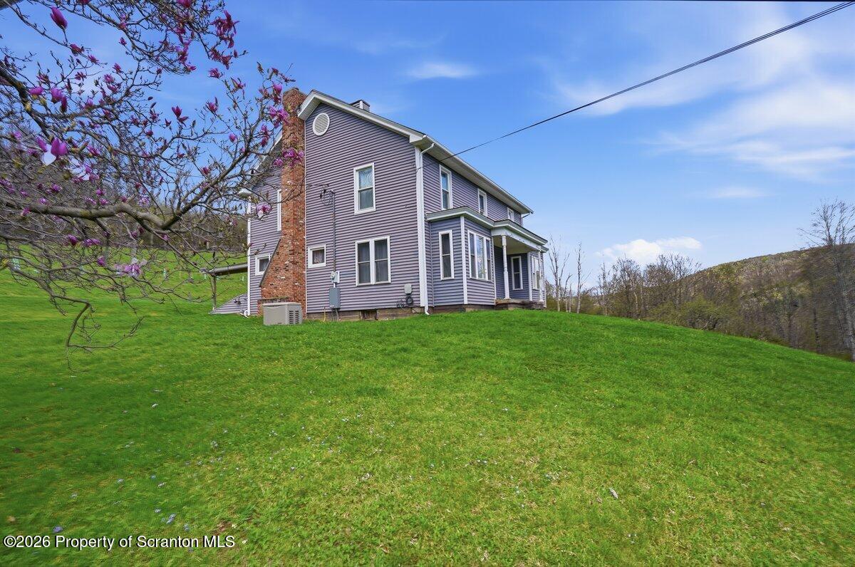 795 Wescott Road New Milford, PA 18834 - Photo 2 of 81 a front view of a house with garden
