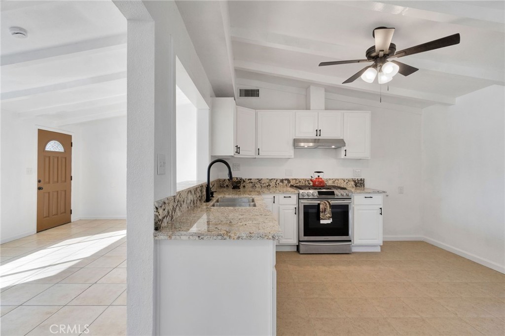 27331 Perkins Road Madera, CA 93637 - Photo 8 of 25 a kitchen with stainless steel appliances granite countertop a sink stove and refrigerator