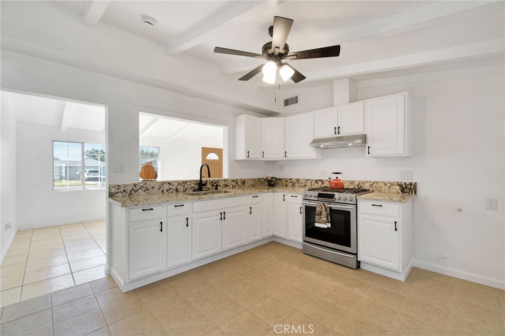 27331 Perkins Road Madera, CA 93637 - Photo 9 of 25 a kitchen with granite countertop a sink cabinets stainless steel appliances and a island
