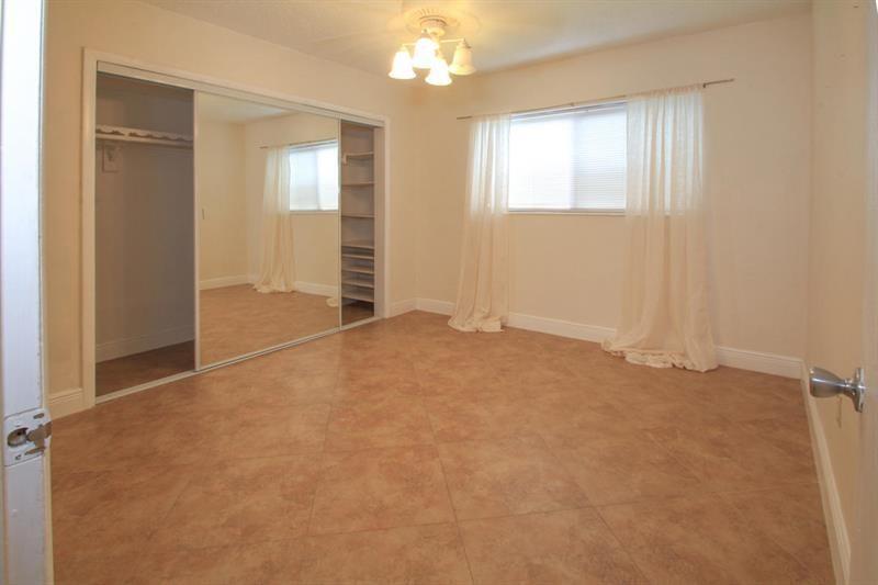 98 Seminole Lane Boca Raton, FL 33487 - Photo 7 of 42 an empty room with windows and closet