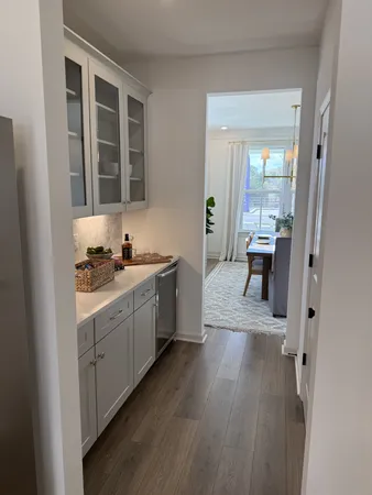 a large white kitchen with sink and dishwasher