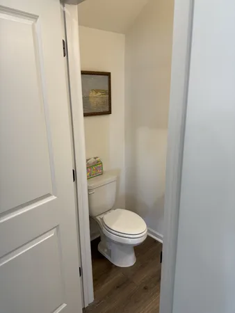 a white toilet sitting next to a shower