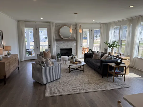 a living room with furniture fireplace and a large window