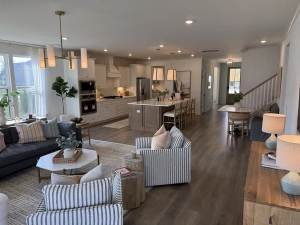 a living room with furniture and kitchen view