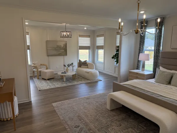 a living room with furniture and a chandelier