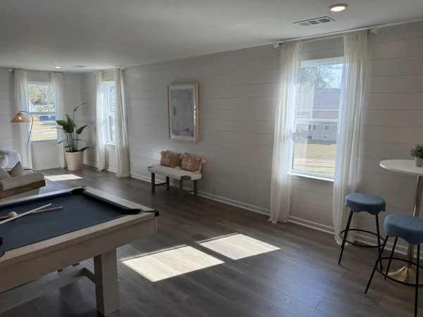 a living room with furniture and wooden floor