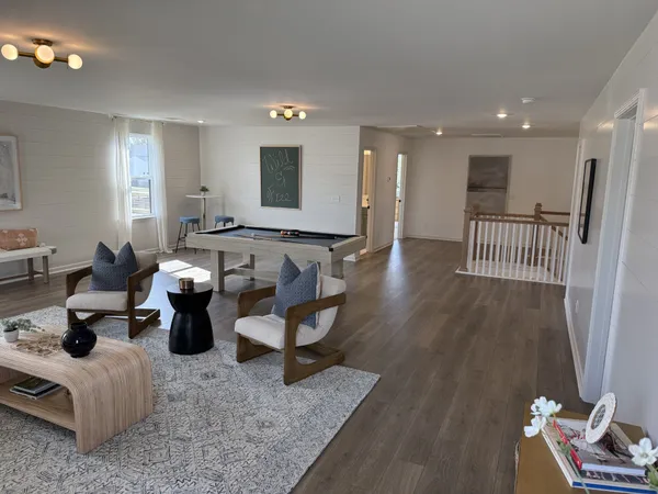 a living room with furniture and a mirror