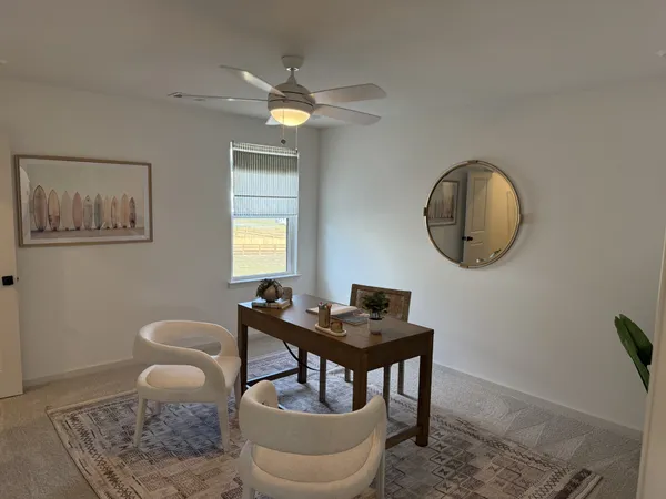 a living room with furniture kitchen view and a large window