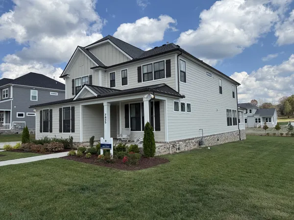 a front view of house with yard and green space