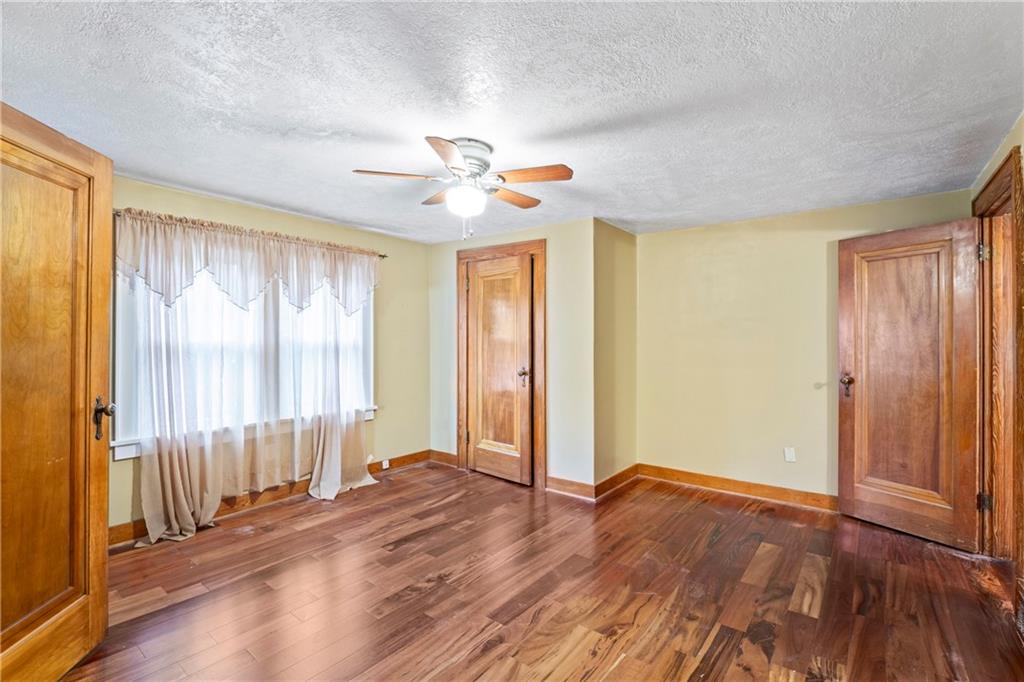 903 37th St Extension Beaver Falls, PA 15010 - Photo 18 of 29 wooden floor in an empty room with a window