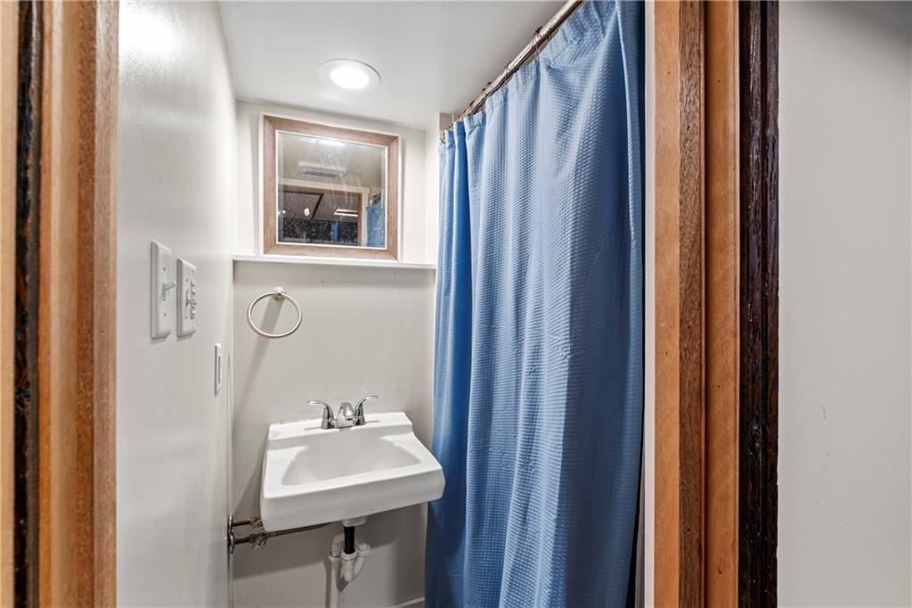 903 37th St Extension Beaver Falls, PA 15010 - Photo 27 of 29 a bathroom with a sink a mirror and a window