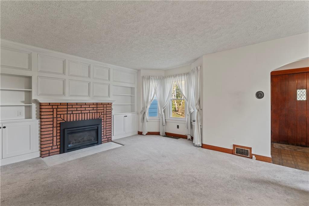 903 37th St Extension Beaver Falls, PA 15010 - Photo 6 of 29 an empty room with furniture and a fireplace