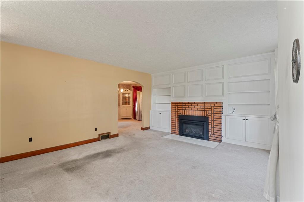 903 37th St Extension Beaver Falls, PA 15010 - Photo 7 of 29 a view of an empty room with a fireplace and a window