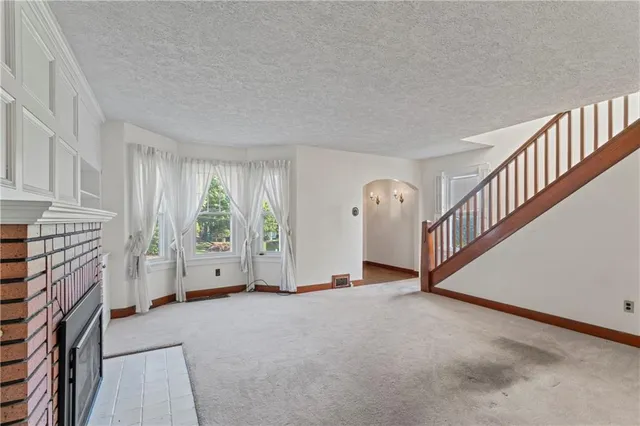 a view of an empty room with a fireplace