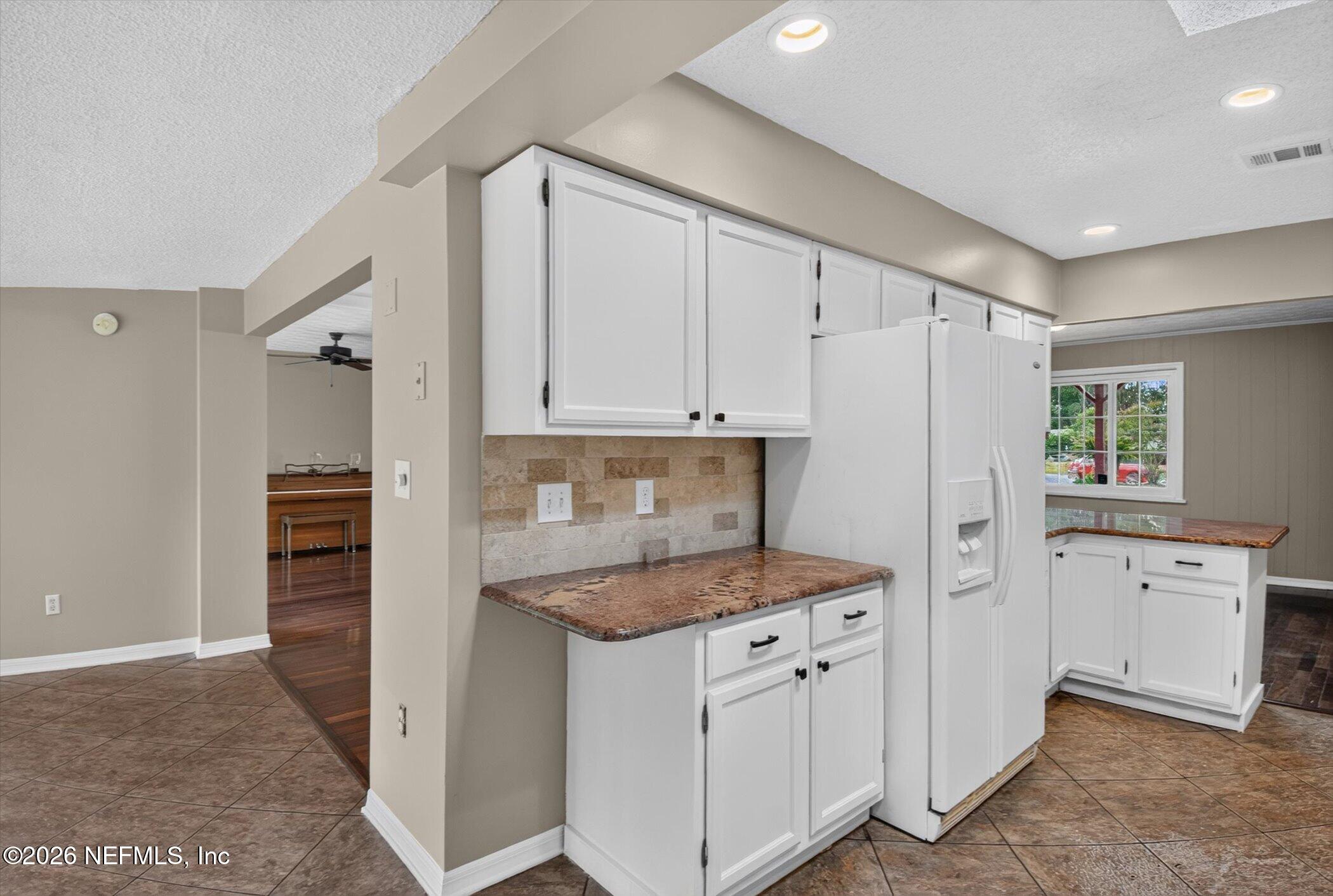 2705 Navajo Road Orange Park, FL 32073 - Photo 23 of 58 a kitchen with white cabinets and refrigerator
