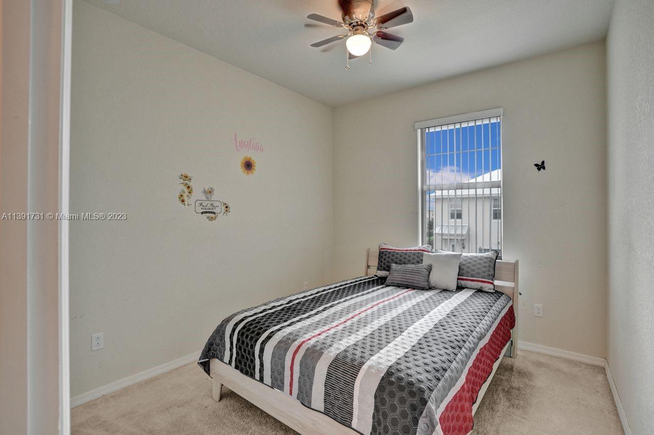 5060 Eucalyptus Drive, Unit 2 Hollywood, FL 33021 - Photo 25 of 56 a bedroom with a bed and a chandelier