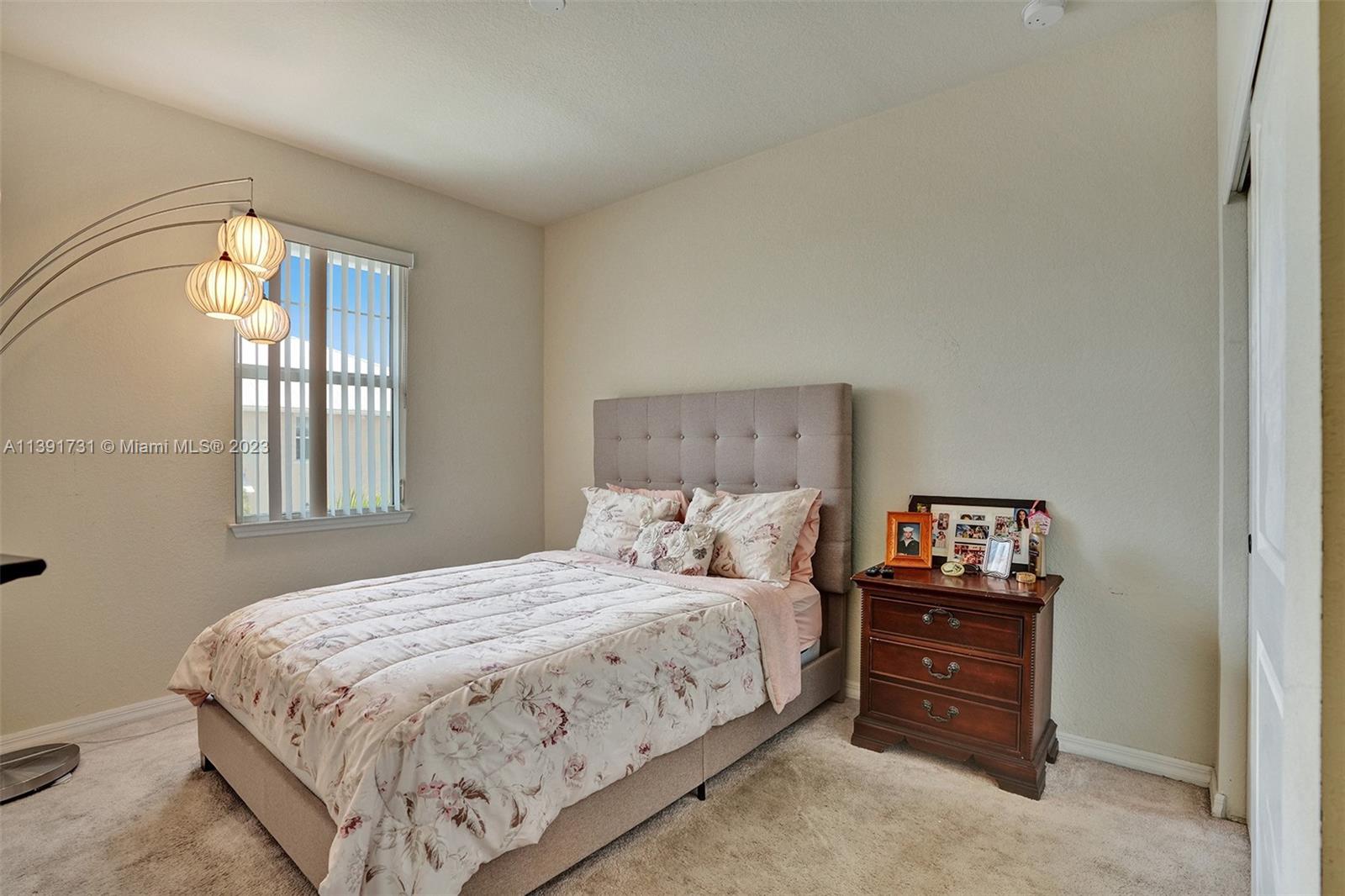 5060 Eucalyptus Drive, Unit 2 Hollywood, FL 33021 - Photo 27 of 56 a bedroom with a bed and a window