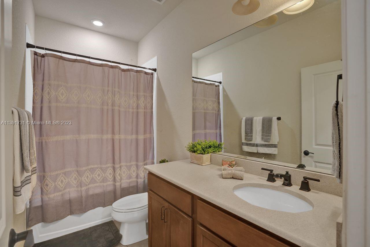 5060 Eucalyptus Drive, Unit 2 Hollywood, FL 33021 - Photo 30 of 56 a bathroom with double sink shower and a toilet
