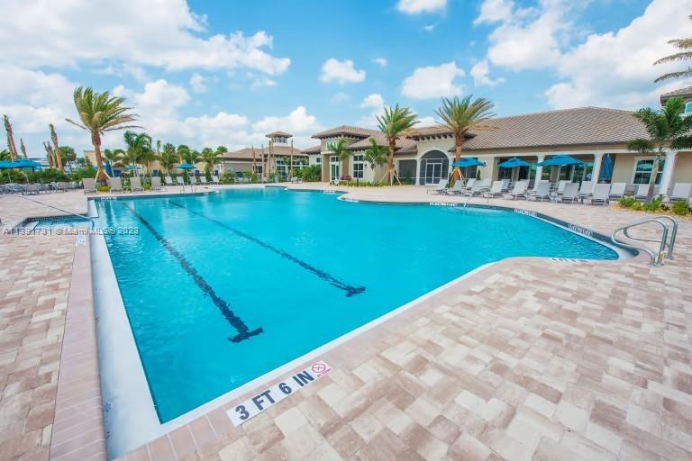 5060 Eucalyptus Drive, Unit 2 Hollywood, FL 33021 - Photo 37 of 56 a view of swimming pool with lawn chairs and plants