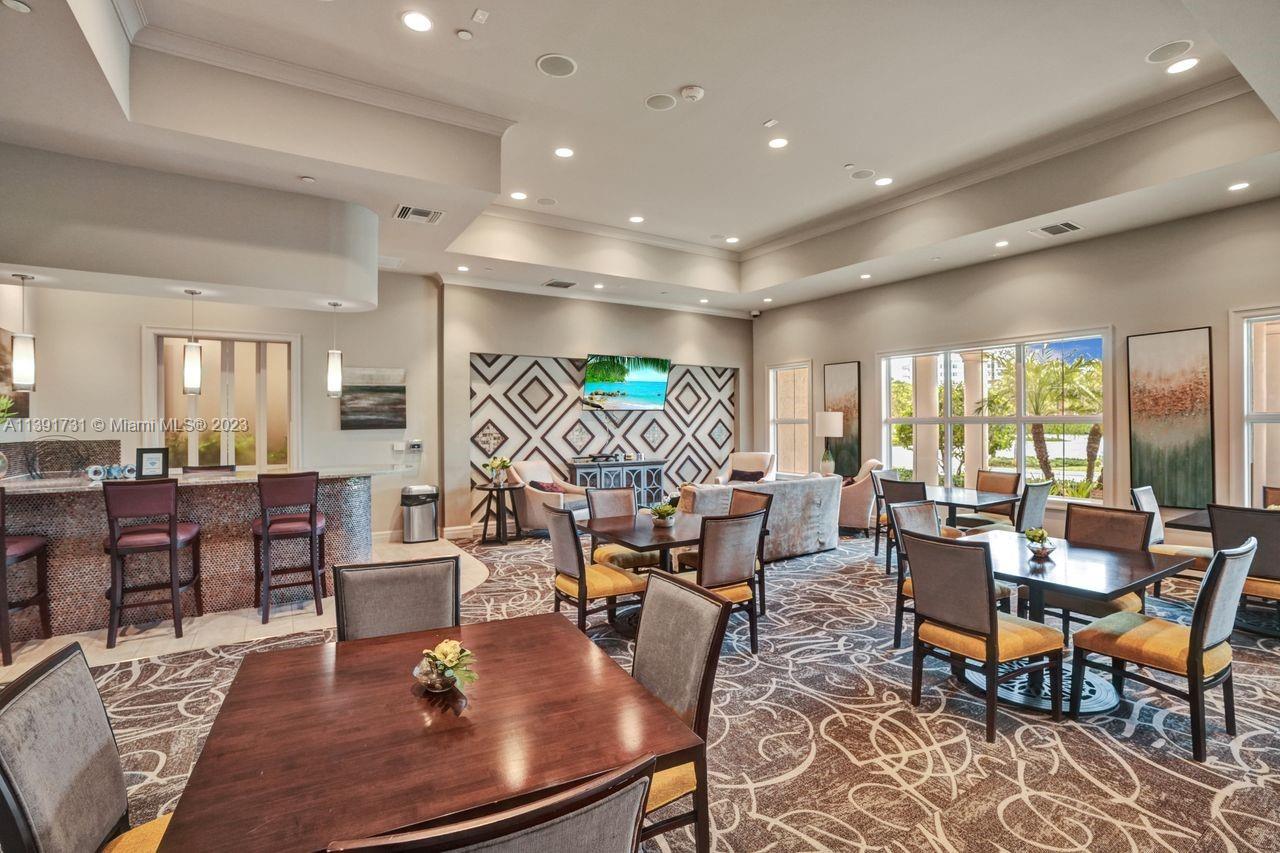 5060 Eucalyptus Drive, Unit 2 Hollywood, FL 33021 - Photo 41 of 56 a living room with lots of furniture a table and chairs