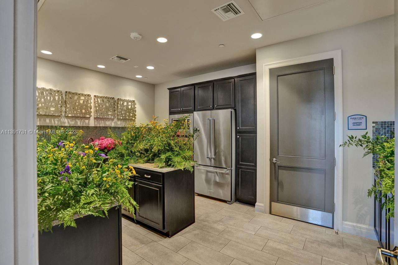 5060 Eucalyptus Drive, Unit 2 Hollywood, FL 33021 - Photo 44 of 56 a kitchen with stainless steel appliances kitchen island granite countertop a refrigerator and a sink