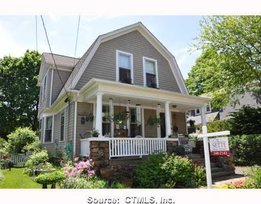 68 Ralston Avenue Hamden, CT 06517 - Photo 1 of 1 a view of a brick house with a flower garden