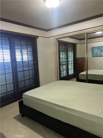 a bedroom with a bed and window