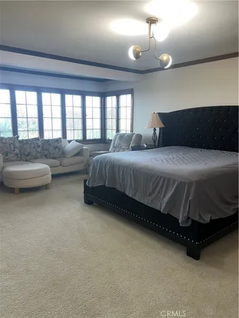 a spacious bedroom with a bed and a couch