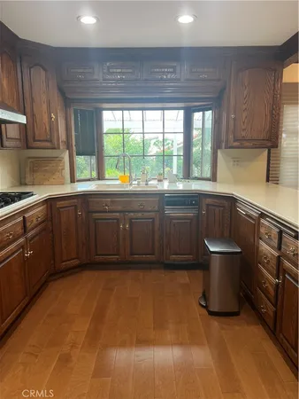 a kitchen with a sink and wooden cabinets