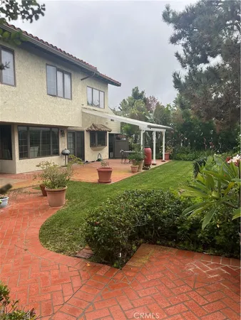 a view of a house with backyard porch and sitting area