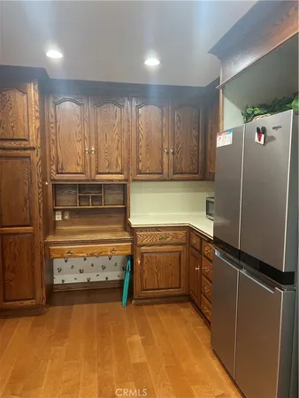a kitchen with stainless steel appliances granite countertop a refrigerator and a sink