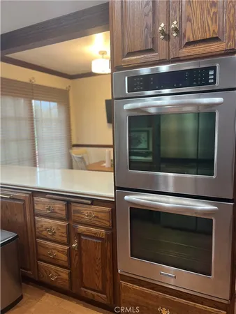 a stove top oven sitting inside of a kitchen and stainless steel appliances