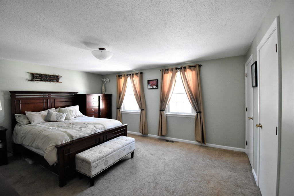 38 Juniper Road, Unit R Derry, NH 03038 - Photo 11 of 22 a bedroom with a bed and a window