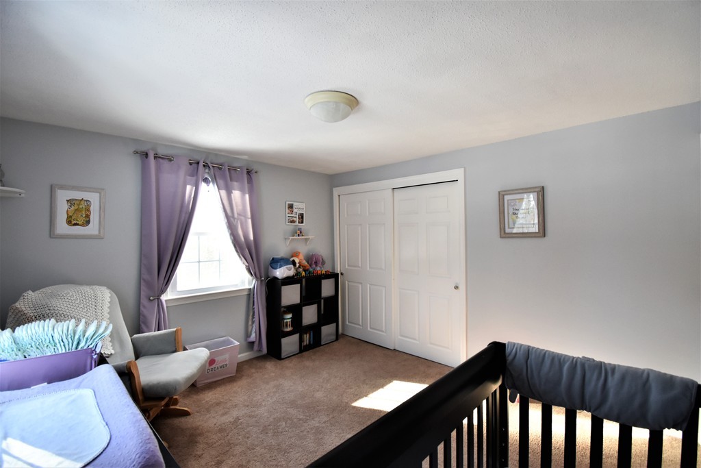 38 Juniper Road, Unit R Derry, NH 03038 - Photo 14 of 22 a bedroom with furniture and a window