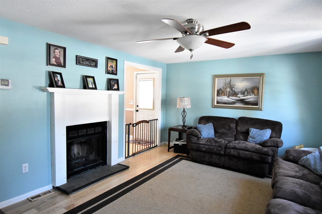 38 Juniper Road, Unit R Derry, NH 03038 - Photo 9 of 22 a living room with furniture and a fireplace