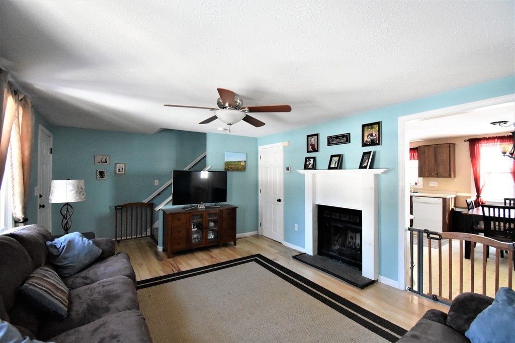 38 Juniper Road, Unit R Derry, NH 03038 - Photo 10 of 22 a living room with furniture and a fireplace